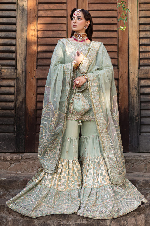 NAQSHI Mah‑e‑Meer potli bag in organza adorned with hand-adda embroidery, tiny crystals and matching embellishments completing the look.